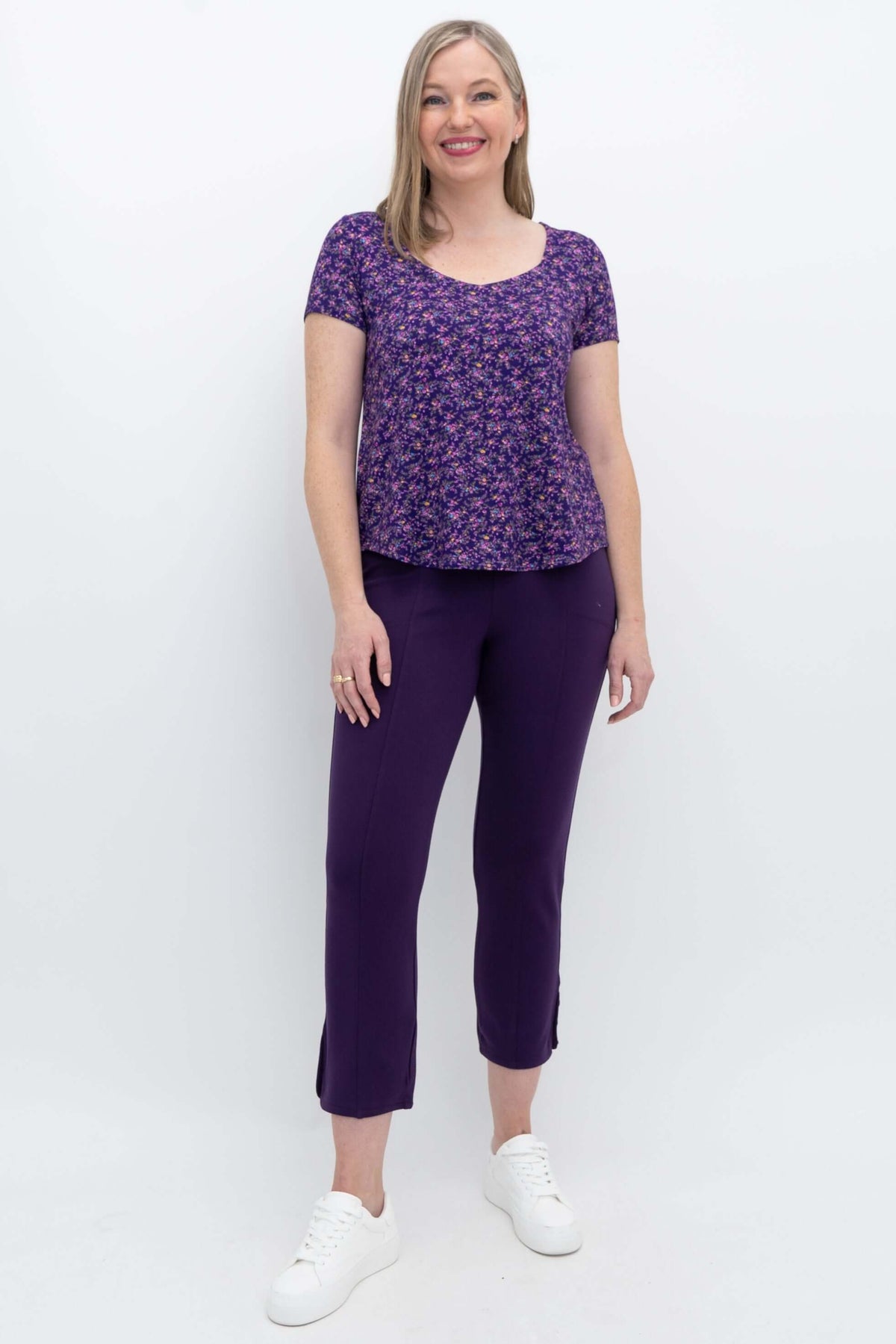Full body shot of model in purple floral Ritzy Short Sleeve Top and pants