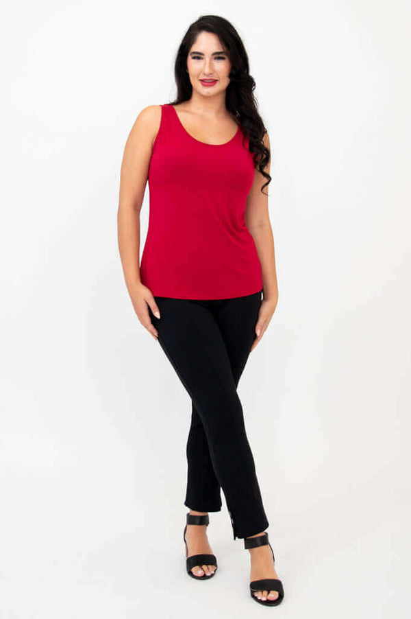 Full body view of woman modeling a red tank top and black slim-fit pants