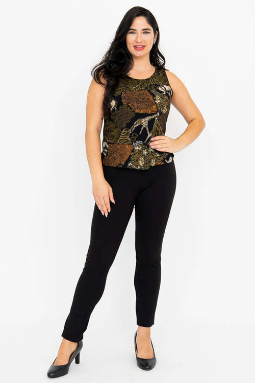 Full-length view of woman in safari print tank top and black pants standing with hand on hip