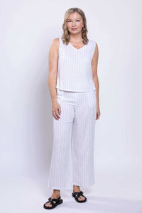 Full body view of woman in a white striped linen tank and matching pants