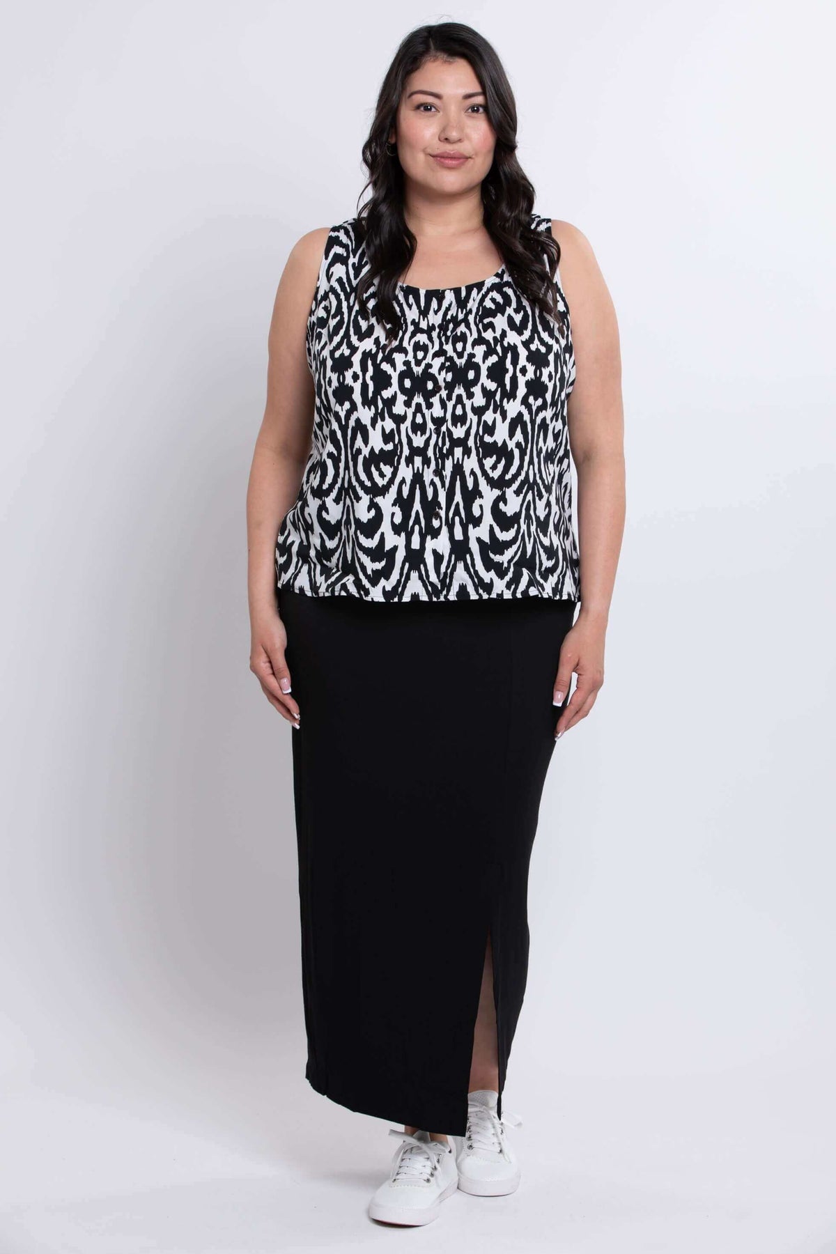 Full body view of model in Ikat print sleeveless tank top and black skirt