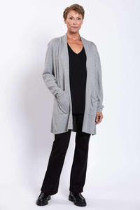 Full body view of model in grey cardigan, black top, and black pants
