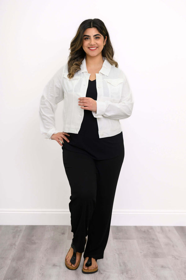 Full body view of model in white linen jacket and black pants facing forward