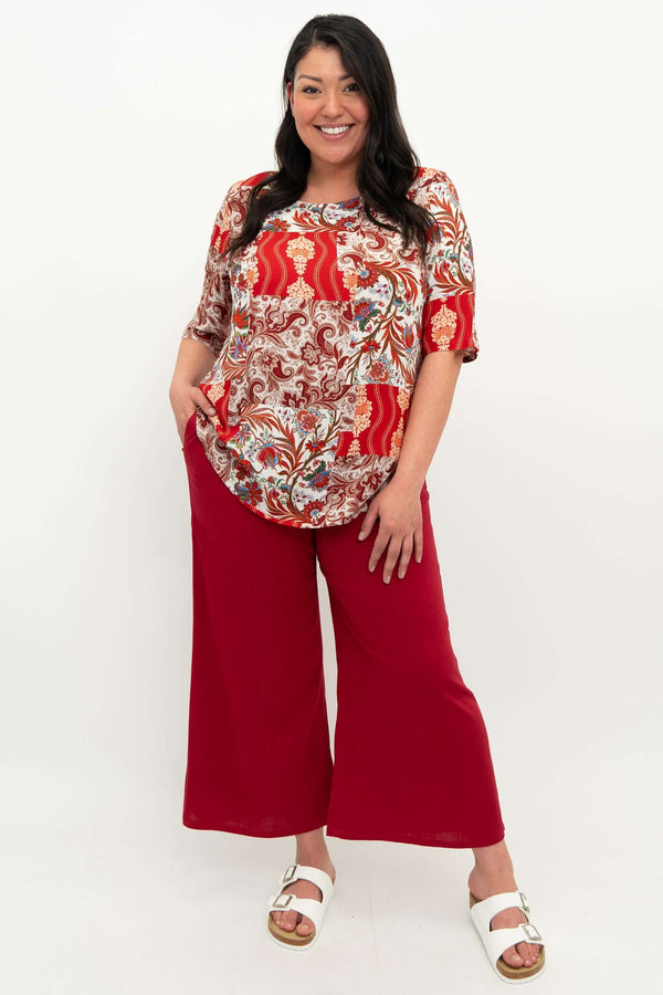 Full body view of model in Liza paisley patchwork blouse and red wide leg pants