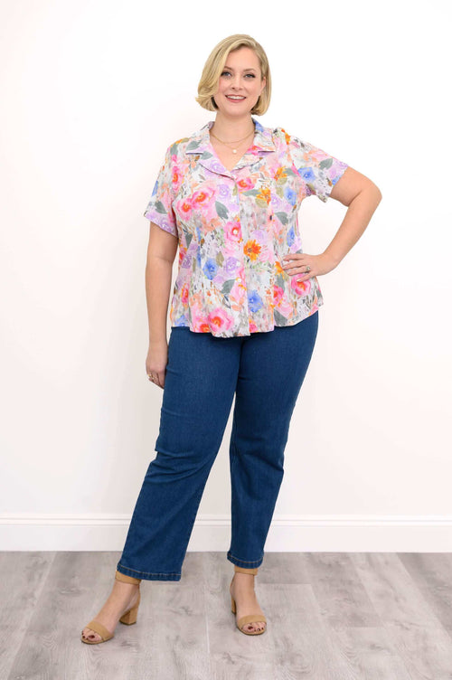 Full body view of a woman modeling the Samantha floral shirt and blue jeans