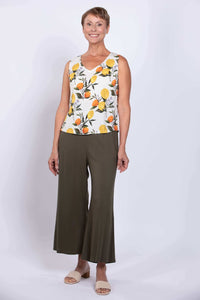Full body front view showing woman in lemon print tank and olive wide-leg pants