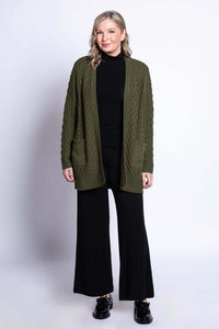 Full body view of woman in olive green cable knit cardigan with black outfit