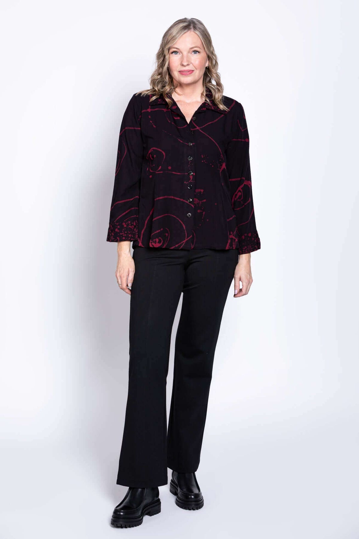 Full body view of woman wearing Ketut blouse and black pants
