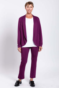 Full body front view of model in plum slim bamboo pants and cardigan