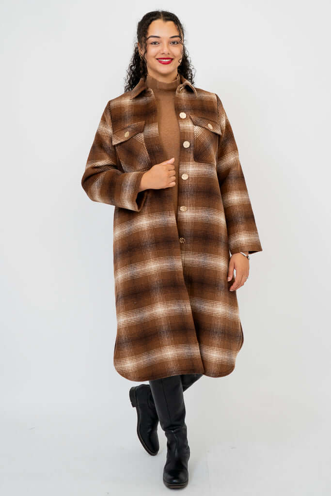 Full frontal view of model in brown plaid knee-length coat with button closure