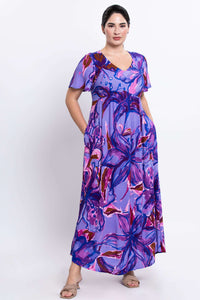 Full front view of a woman in a vibrant purple floral empire waist maxi dress