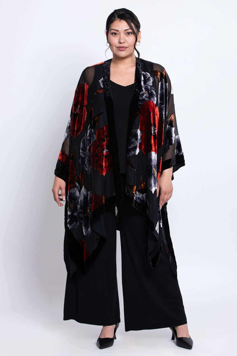 Woman wearing a black floral kimono wrap with red and grey flowers, full front view