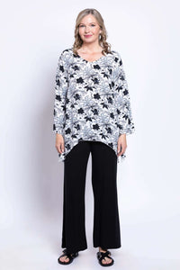 Full front view of model in floral bohemian top and wide-leg black pants