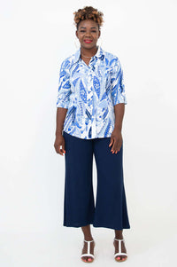Full front view of woman modeling blue and white paisley blouse with navy pants
