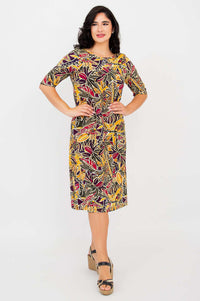 Full front view of Olivia dress in Tropikal print worn by a woman with hands on waist