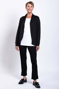 Woman standing in black French Terry jacket, white top, and black pants, full front view