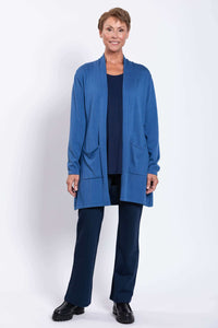 Full front view of a woman wearing a blue cardigan and navy pants
