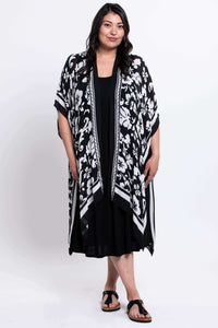 Full front view of model in black and white floral kimono wrap