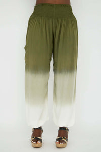 Full front view of olive and cream ombre wide-leg pants with pockets, model in sandals