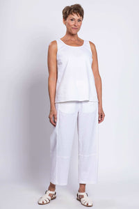 Full front view of woman in white sleeveless linen tank and matching pants