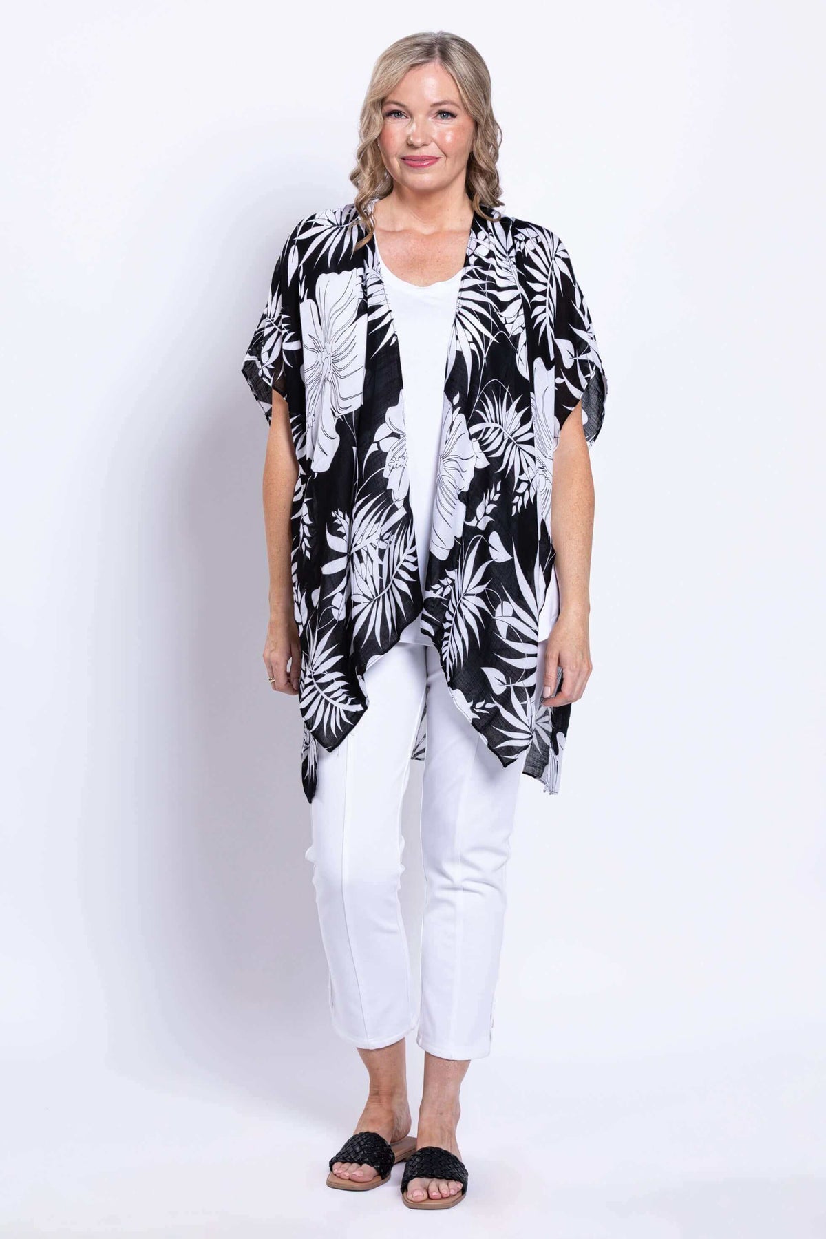Full frontal view of a woman in a casual black and white floral kimono wrap