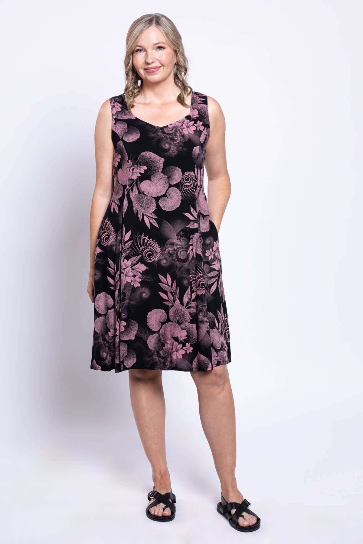 Full length front view of woman in Sweet Sara A-Line dress, pink botanica print