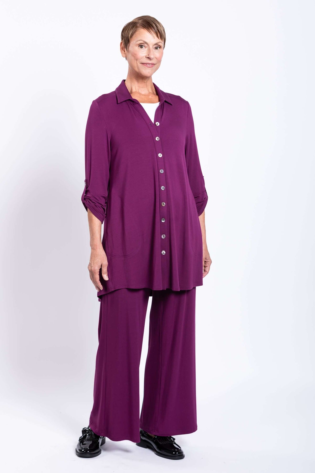 Full body view of a model in a plum tunic and matching wide-leg pants