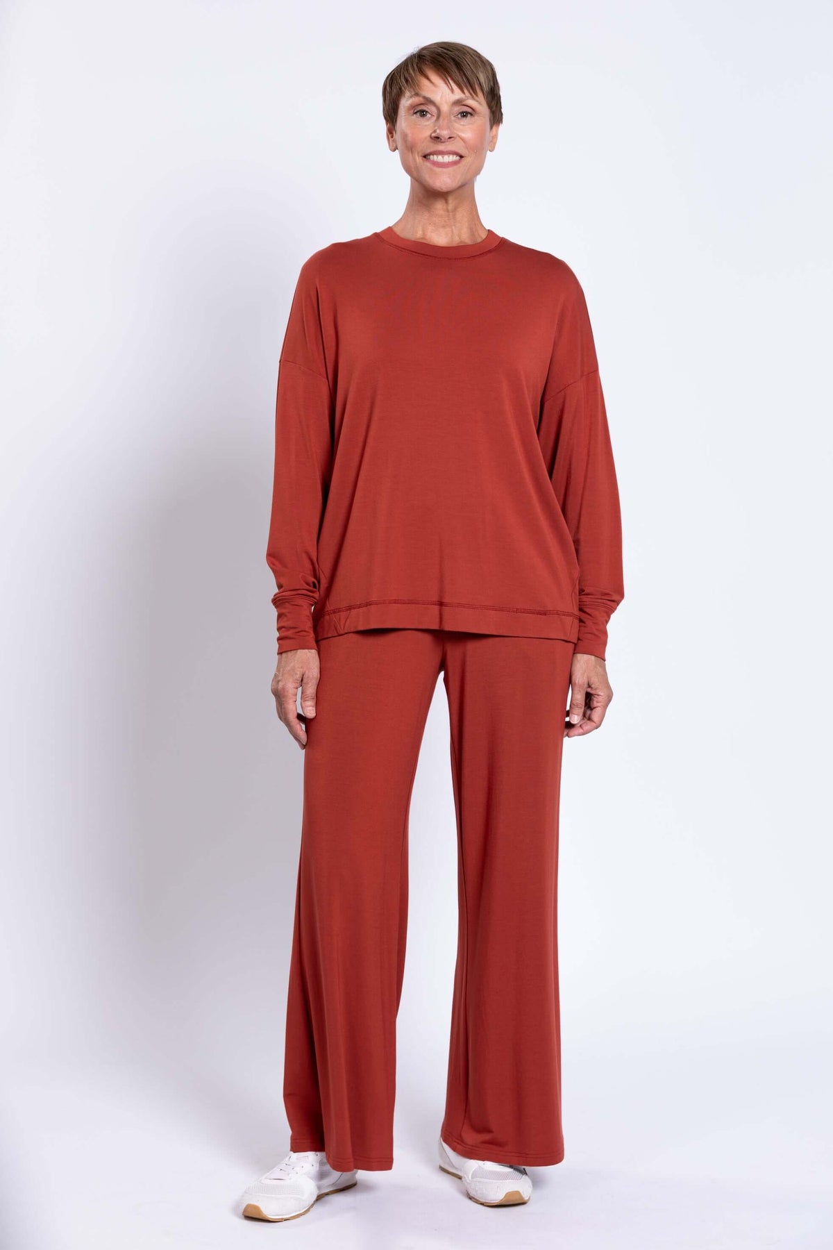 Woman standing in full outfit with relaxed fit bamboo crew neck top and wide leg pants