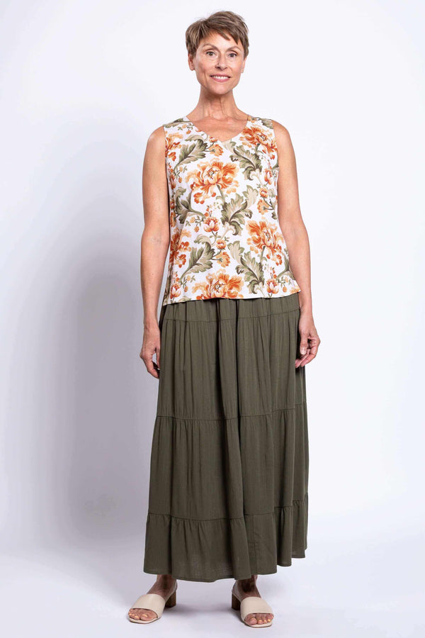 Full body view of a woman wearing the floral cropped tank with an olive green maxi skirt