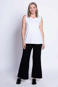 Full body shot of model in white sleeveless tank top and black pants