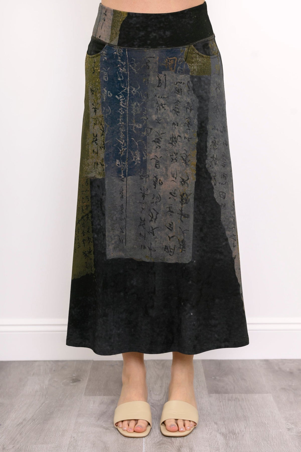 A-line earth-toned printed midi skirt featuring a comfortable flat waistband, shown on a white background.