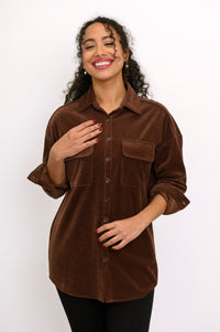 Medium shot of a women's relaxed-fit brown cotton corduroy shacket buttoned up