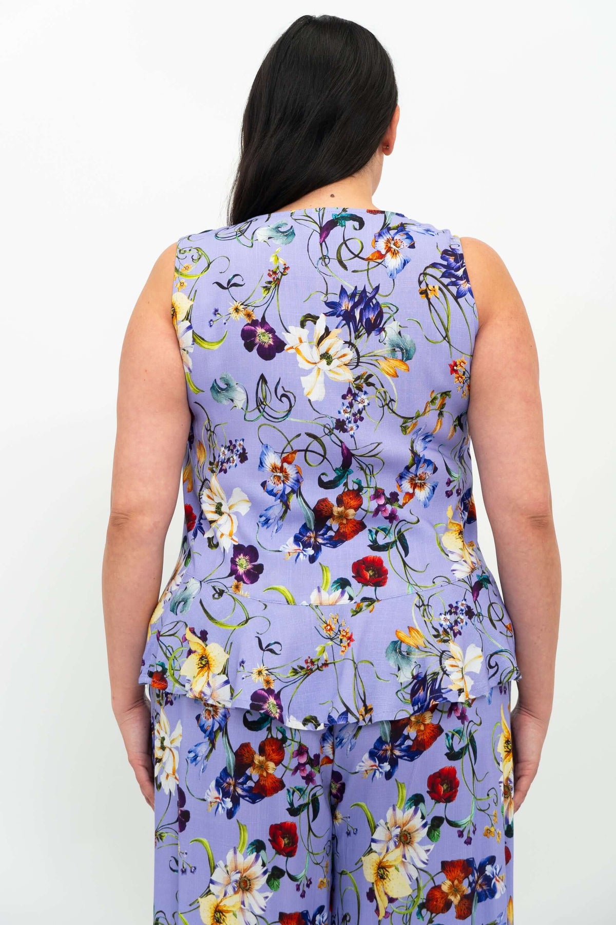 Back view of the Ginny Tank, highlighting lavender floral print and peplum