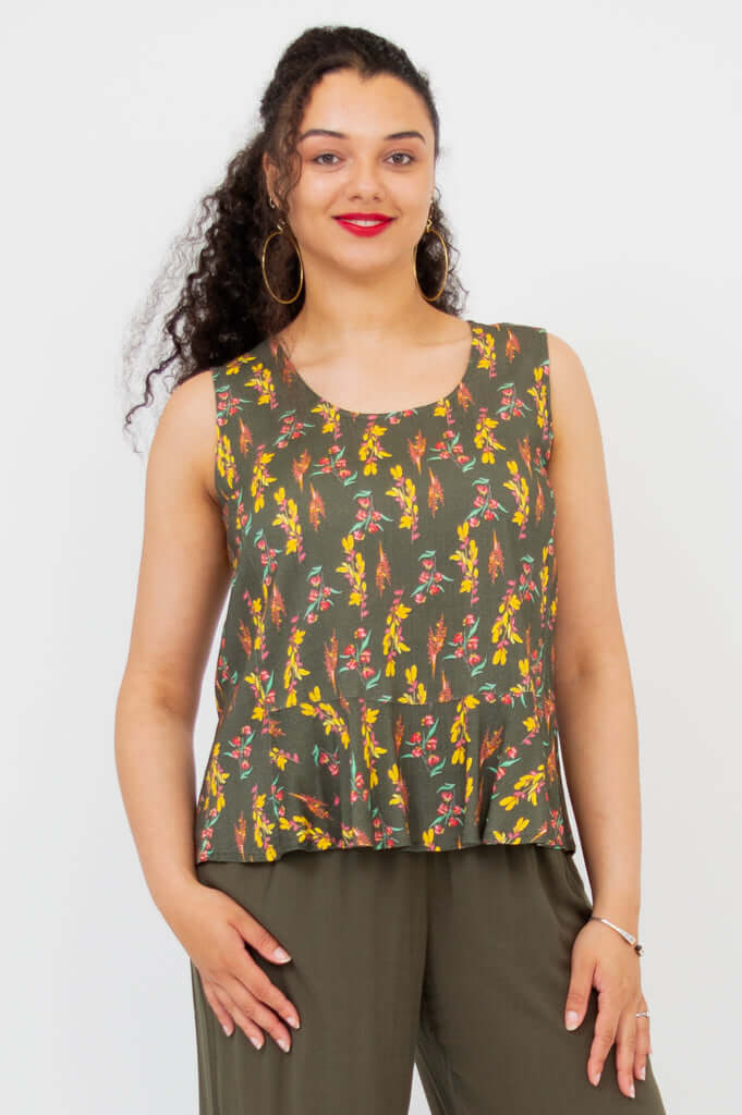 Front view of model wearing olive floral Ginny Tank with wide straps and peplum hem