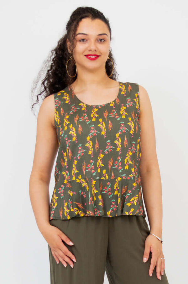 Front view of model wearing olive floral Ginny Tank with wide straps and peplum hem