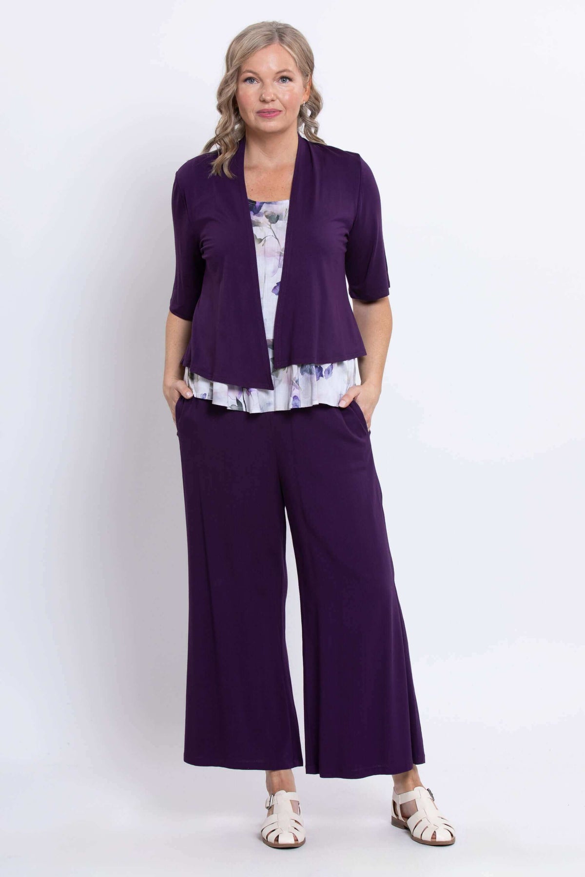 Model wearing Ginny Tank underneath purple open cardigan and matching pants