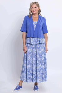 Woman wearing blue cropped jacket over blue floral Ginny tank top and matching skirt