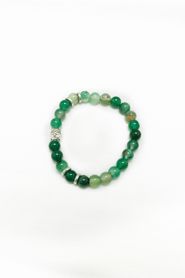 Green agate beaded bracelet with silver Buddha charm and spacers on a white background
