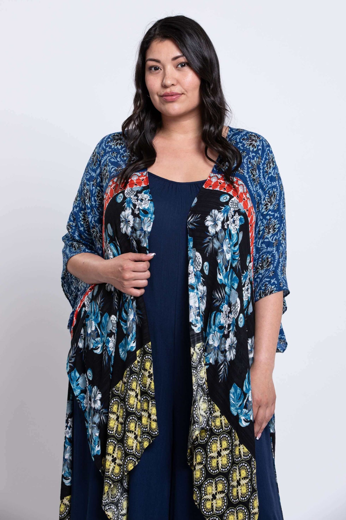 Half body front angle of woman in Darcy kimono wrap showing draped sleeves and vibrant design