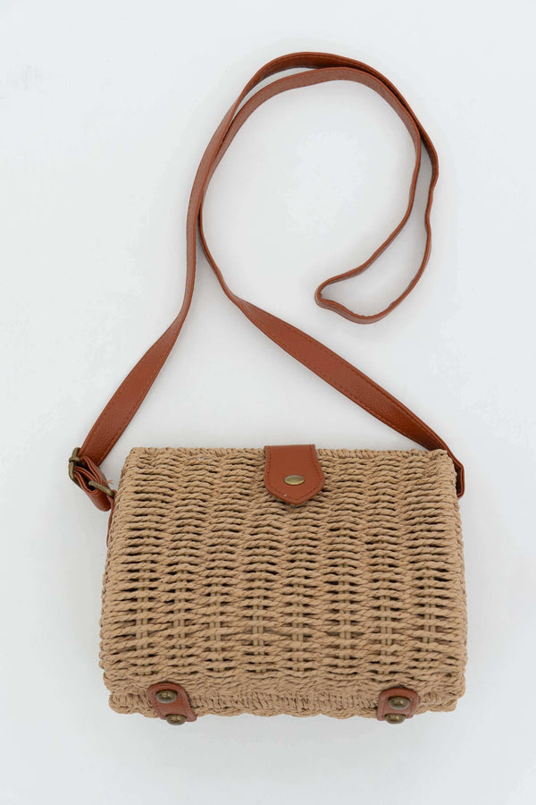 Handwoven rattan crossbody bag with adjustable brown faux leather strap