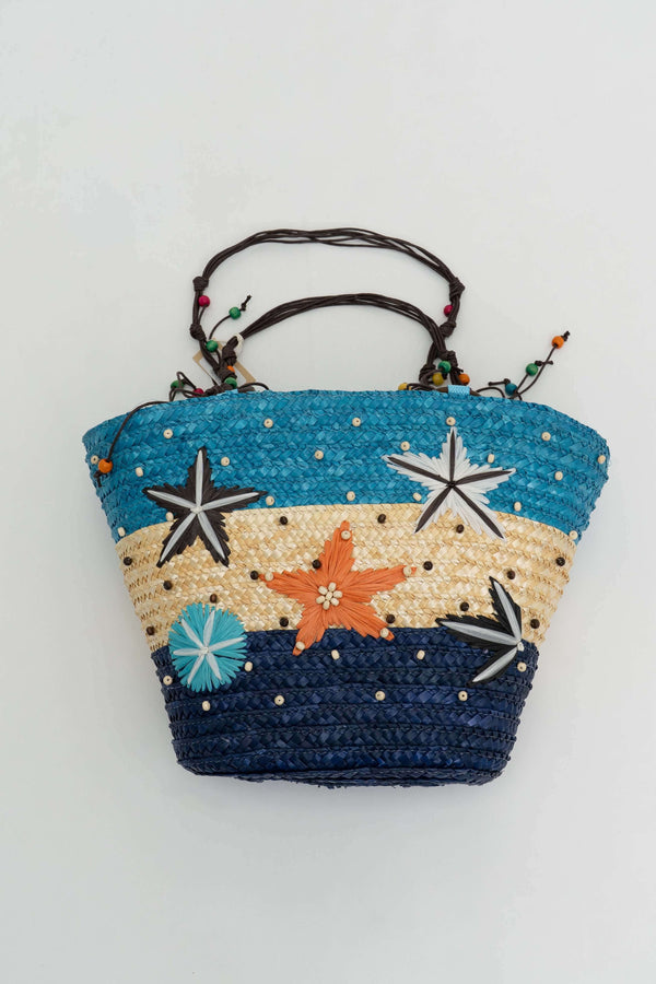 Handwoven rattan tote bag in blue, beige, and navy with colorful star and bead accents