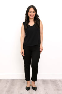 Front view of a woman wearing the Havana Tank in black linen bamboo fabric paired with matching black pants.