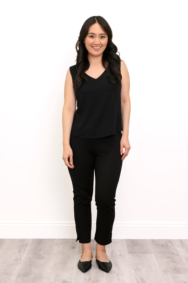 Front view of a woman wearing the Havana Tank in black linen bamboo fabric paired with matching black pants.