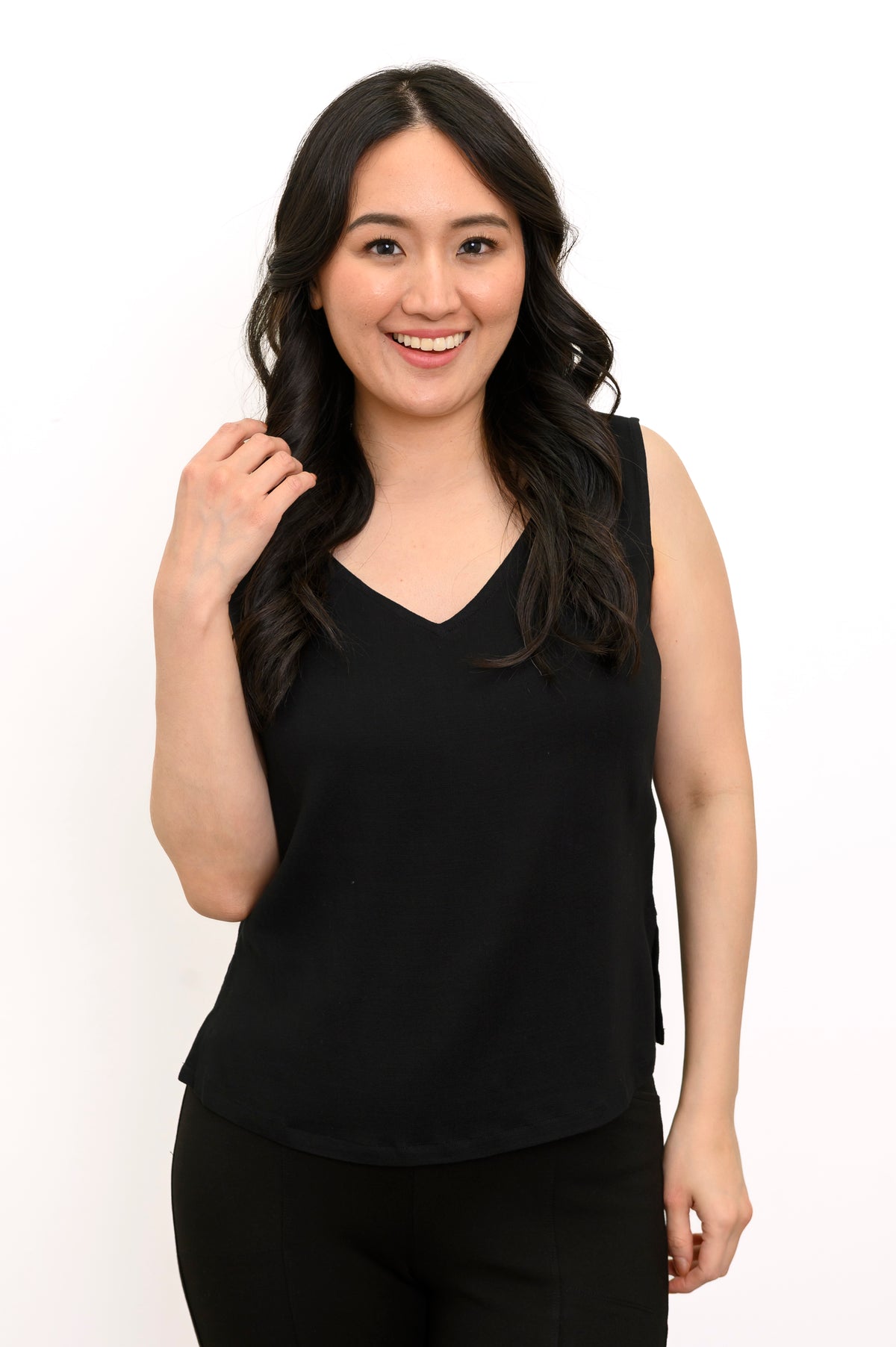Front view of a woman wearing the Havana Tank in black linen bamboo fabric with a V-neckline.