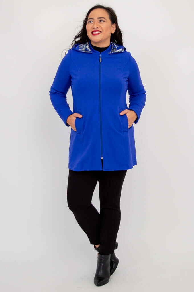 Front view of Highlands Coat zipped up with hands in pockets
