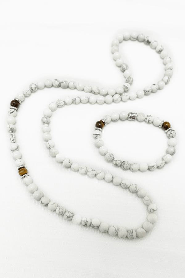 Howlite beaded mala and bracelet set featuring white marbled beads with metallic and brown accent beads