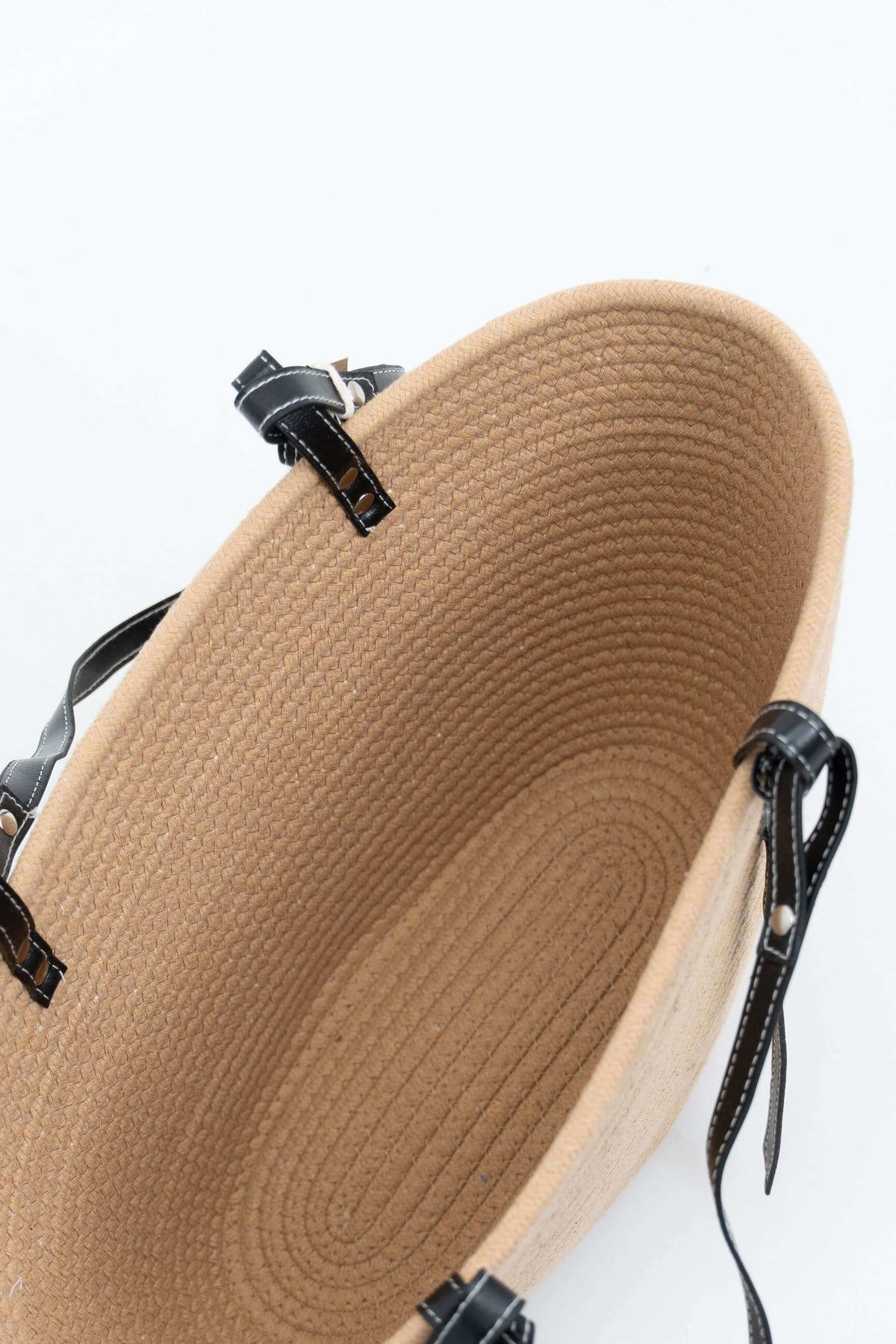 Interior view of a spacious tan cotton tote bag with black straps