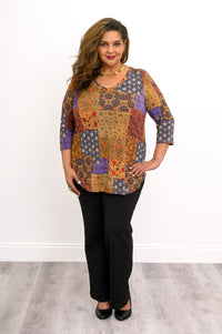 Yellow and brown mosaic pattern 3/4 sleeve bamboo top paired with black pants, shown against a white wall.