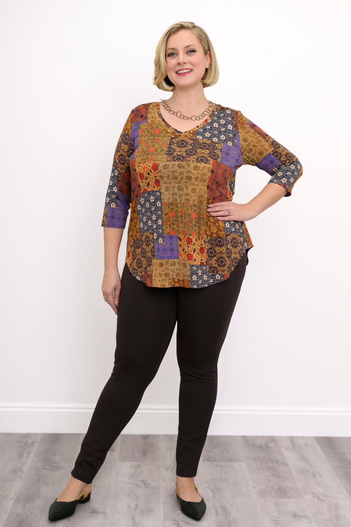 Side view of a flowy yellow geometric print bamboo blouse with 3/4 sleeves and a gentle A-line silhouette.