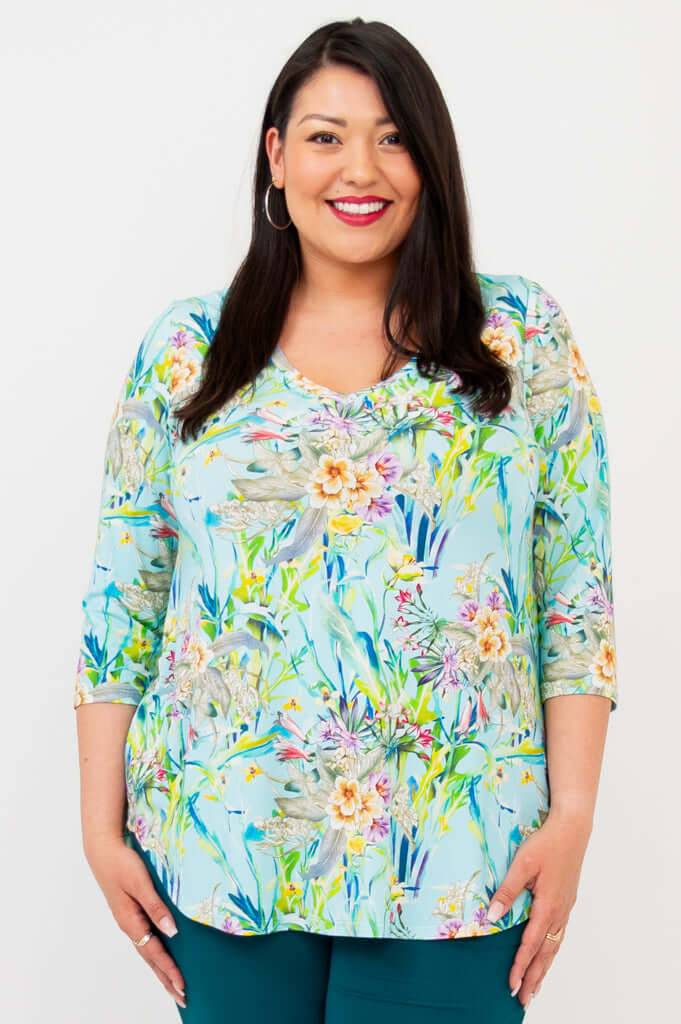 Model wearing Jackie V-Neck Bamboo Top in Spring Meadow print, smiling
